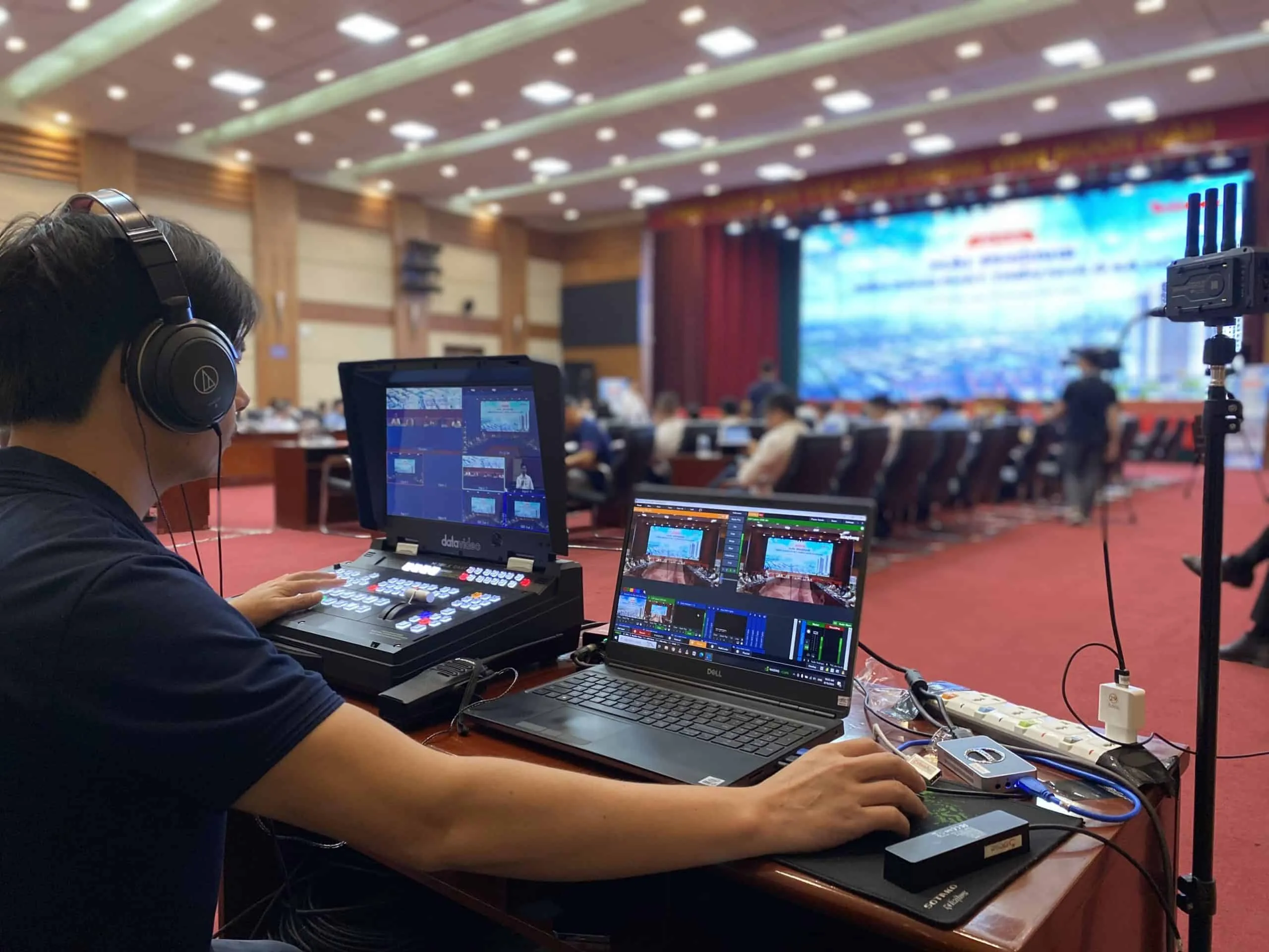 ProMedia technician operating a broadcast switcher for a hybrid livestream in Vietnam