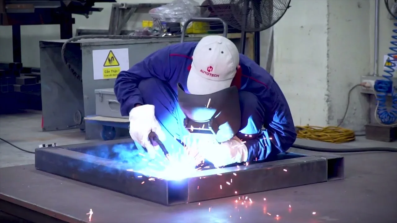 Certified industrial welder working on machinery frame